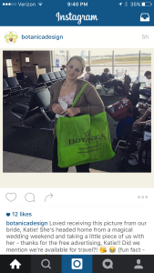 Thanks to a big, vibrant branded Botanica International tote bag, a beaming bride, en route to her honeymoon, lets all her fellow travelers know who styled her wedding. 