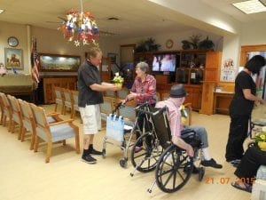 Dave Smith, a driver for Allan's Flowers & More in Prescott, Arizona, delivered Make Someone Smile designs to the Arizona Pioneer's Retirement Home last year. 