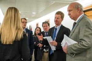 Art Van Wingerden of Metrolina Greenhouses in Huntersville, North Carolina, leads the discussion during a meeting in a Capitol hallway — a not uncommon occurrence for busy congressional staffers.